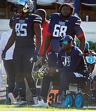 Jackson State University Coach Deion Sanders watches from the sidelines on his motorized scooter during his team’s Oct. 16 game against Alabama State University in Jackson, Miss. Since then, Coach Sanders has been hospitalized and missed three games. He returned to the sidelines last Saturday using a motorized wheelchair.