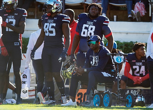 Jackson State University Coach Deion Sanders watches from the sidelines on his motorized scooter during his team’s Oct. 16 game against Alabama State University in Jackson, Miss. Since then, Coach Sanders has been hospitalized and missed three games. He returned to the sidelines last Saturday using a motorized wheelchair.