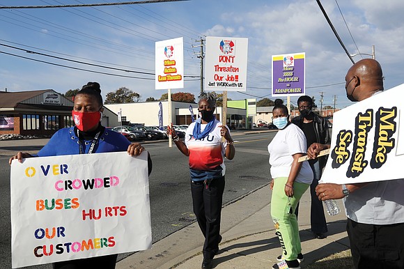 Active drivers and retired bus operators hold up signs to passing vehicles Nov. 10 as they conduct informational picketing in ...