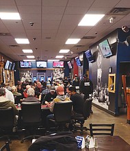 Tables at Pop’s bar & Grill on Giant Drive in South Side are filled with betting customers playing Texas Hold ‘em.