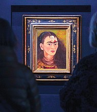 Visitors view Frida Kahlo’s painting “Diego and I” during a media preview Nov. 5 at Sotheby’s auction house. The painting, an artist self-portrait that shows the face of her husband, Diego Rivera, in the middle of her forehead, sold Nov. 16 for $34.9 million.