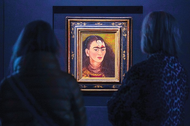 Visitors view Frida Kahlo’s painting “Diego and I” during a media preview Nov. 5 at Sotheby’s auction house. The painting, an artist self-portrait that shows the face of her husband, Diego Rivera, in the middle of her forehead, sold Nov. 16 for $34.9 million.