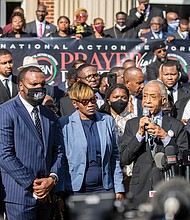 The Rev. Al Sharpton, second from right, is flanked by Ahmaud Arbery’s parents, Wanda Cooper-Jones, left, and Marcus Arbery, right, as he speaks Nov. 18 to roughly 750 pastors and supporters of the late Mr. Arbery outside the Glynn County Courthouse in Brunswick, Ga., during a Wall of Prayer event. A defense attorney for one of the three white men charged with Mr. Arbery’s murder objected to the presence of the Rev. Jesse Jackson, Rev. Sharpton and other Black pastors in the courtroom and asked the judge to keep them out. The judge rejected the request as “reprehensible.” At far left is Martin Luther King III, son of slain civil rights leader Dr. Martin Luther King Jr.