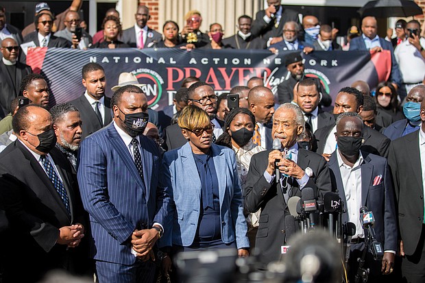 The Rev. Al Sharpton, second from right, is flanked by Ahmaud Arbery’s parents, Wanda Cooper-Jones, left, and Marcus Arbery, right, as he speaks Nov. 18 to roughly 750 pastors and supporters of the late Mr. Arbery outside the Glynn County Courthouse in Brunswick, Ga., during a Wall of Prayer event. A defense attorney for one of the three white men charged with Mr. Arbery’s murder objected to the presence of the Rev. Jesse Jackson, Rev. Sharpton and other Black pastors in the courtroom and asked the judge to keep them out. The judge rejected the request as “reprehensible.” At far left is Martin Luther King III, son of slain civil rights leader Dr. Martin Luther King Jr.