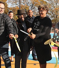 City Councilwoman Ellen F. Robertson, 6th District, second from right, cuts the ribbon to formally open the new basketball courts in the Hillside Court public housing community in South Side. Joining in the ceremony last Saturday are, from left, Nicholas J. “Nick” Cooper of Citizen HKS, the nonprofit that led the design effort with residents; Tavares Floyd, Ms. Robertson’s council liaison; and Ralph Stuckey, director of resident services for the Richmond Redevelopment and Housing Authority.