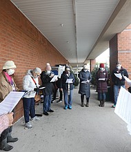 Rev. Patricia Shipley, fourth from left, a board member of the Richmond-based Virginia Interfaith Center for Public Policy leads campaign supporters in a prayerful litany outside South Richmond Food Lion. Joining her are members of the Greater Richmond Branch of the American Association of University Women, Virginia Organizing and Green New Deal who were there to advocate on behalf of workers.