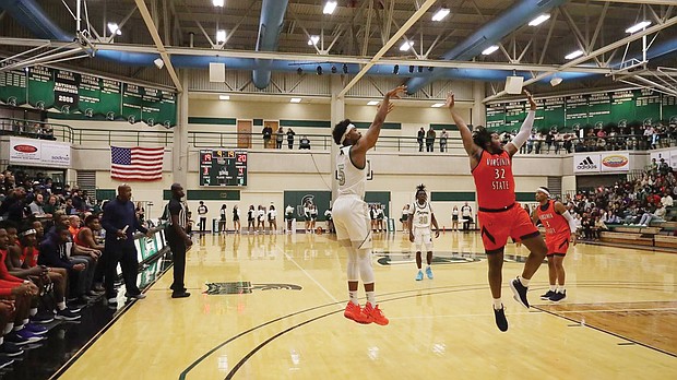 University of Mount Olive’s Jeremiah Phifer jumps and shoots over Virginia State University’s Dajour Rucker Nov. 19 in the Pickle Classic. VSU beat Mount Olive 99-95, and then lost on Nov. 20 to Barton College 105-90 in the second matchup of the classic.