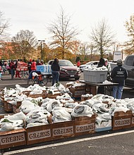 More than 300 volunteers help distribute food for Thanksgiving dinners at The Saint Paul’s Baptist Church’s annual giveaway last Saturday done in concert with roughly 40 other area churches, organizations and businesses. A long line of cars drove through the parking lot of the church’s North Campus at 4247 Creighton Road in Henrico County, where volunteers loaded greens, stuffing, muffin mix and all the ingredients for a holiday meal. COVID-19 vaccines and booster shots also were available.