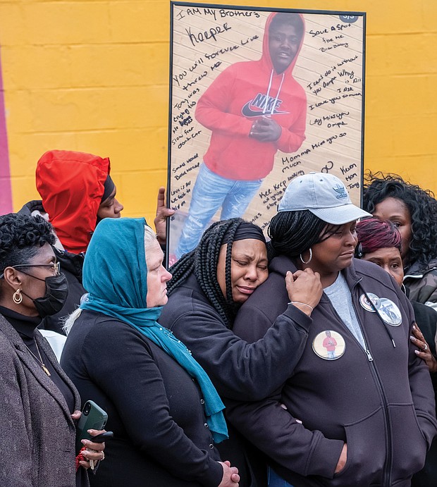 Family members of Rah’quan Logan mourn during a gathering Sunday to remember and honor the 14- year-old’s life held outside the OMG Convenience Store at Creighton and Nine Mile Roads where he was gunned down Nov. 12 in a quadruple shooting. Nine-year-old Abdul bani-Ahmad, whose family owns the store, also was killed, while two men were wounded. More than 100 people attended the vigil, including City Council President Cynthia I. Newbille and Richmond School board Chairwoman Cheryl L. Burke. Many brought silver and black balloons to honor Rah’quan. James “J.J.” Minor III, president of the Richmond branch NAACP, called on parents and others to stop the violence and asked faith-based organizations to provide support for families. Rah’quan’s funeral was held Tuesday morning at Walter J. Manning Funeral Home in Church Hill with burial in Oakwood Cemetery.