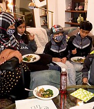 Asghary's family enjoys its first Thanksgiving meal.
Mandatory Credit:	CNN