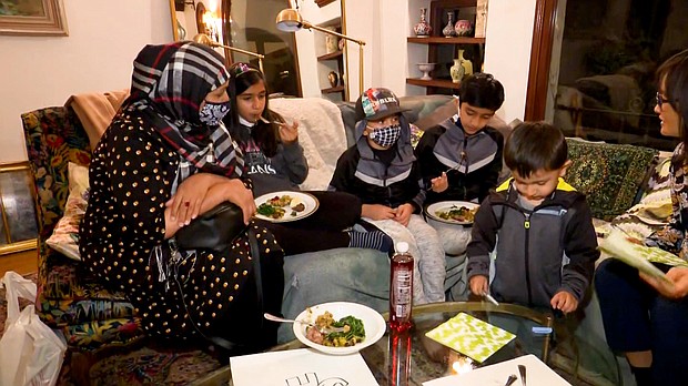 Asghary's family enjoys its first Thanksgiving meal.
Mandatory Credit:	CNN