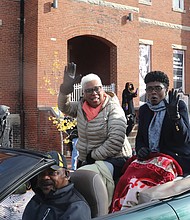 Richmond School Board Chairwoman Cheryl L. Burke, left, and Richmond City Council President Cynthia I. Newbille wave to the crowd as they ride on the back of a convertible in the parade.