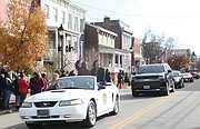 Richmond Mayor Levar M. Stoney and his girlfriend, Brandy Washington, wave to the crowd from their perches on the back of a classic Mustang during last Saturday’s parade.