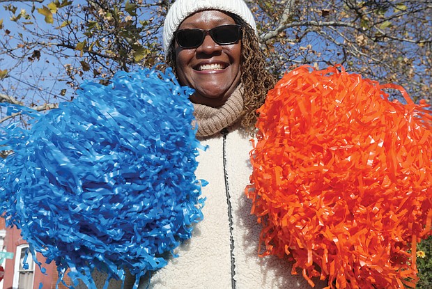 Monica Nicholson of Sandston shakes blue and orange pompomms, Armstrong High School’s colors, where her mother, Janie Preston of Chesterfield, was a cheerleader before graduating in 1960.