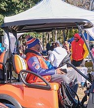 Glenn Anderson, student activities director at Armstrong High School, looks out on the crowd of tailgaters in the parking lot of Hovey Stadium at VUU from his vantage point in a golf cart.