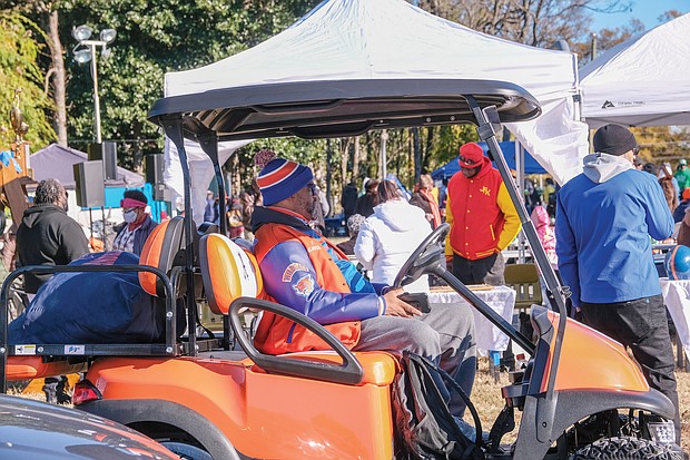 Glenn Anderson, student activities director at Armstrong High School, looks out on the crowd of tailgaters in the parking lot of Hovey Stadium at VUU from his vantage point in a golf cart.