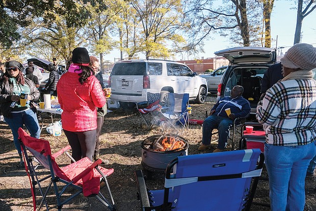 Tailgaters enjoy a fire pit during the tailgate party on the VUU campus following the parade.