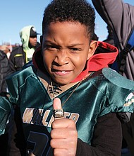 Dyron Davis Jr. shows off the championship ring he won, along with his teammates on the RVA Justices 8U youth football team, at last Saturday’s Armstrong-Walker Classic Legacy. The game, held at Willie Lanier Field at Hovey Stadium on Virginia Union University’s campus, followed a morning parade to revitalize the community spirit of the original annual event held from 1938 to 1978.