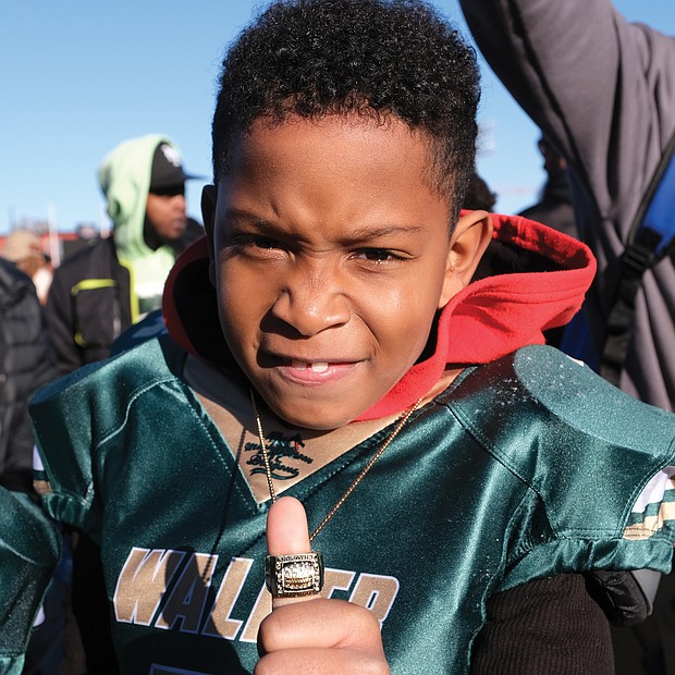 Dyron Davis Jr. shows off the championship ring he won, along with his teammates on the RVA Justices 8U youth football team, at last Saturday’s Armstrong-Walker Classic Legacy. The game, held at Willie Lanier Field at Hovey Stadium on Virginia Union University’s campus, followed a morning parade to revitalize the community spirit of the original annual event held from 1938 to 1978.