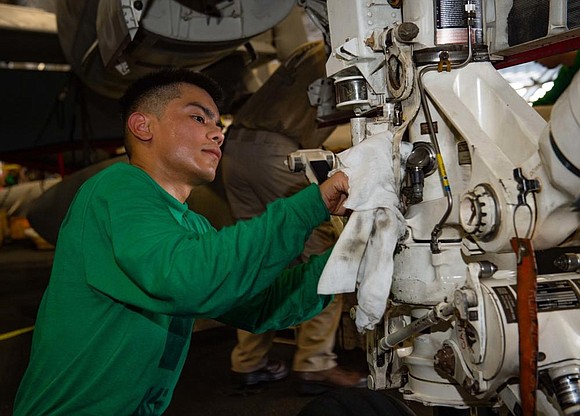 viation Electrician’s Mate Airman Lopez Cervantes, a native of Houston, conducts maintenance in the hangar bay of Nimitz-class aircraft carrier …