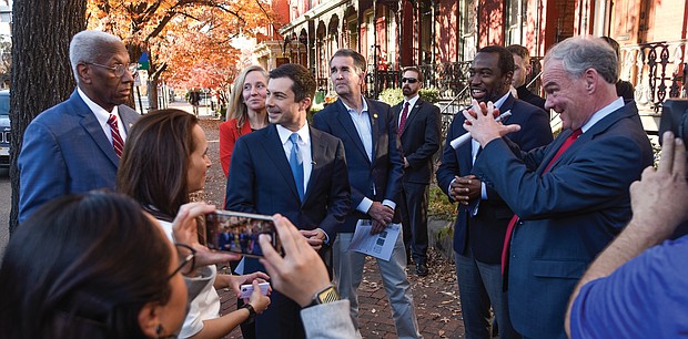 U.S. Secretary of Transportation Pete Buttigieg, center, listens as Virginia elected officials talk about how Jackson Ward was dissected with the construction of Interstate 95. Taking him on a tour of the Richmond neighborhood Dec. 3 are, from left, U.S. Rep. A. Donald McEachin, U.S. Rep. Abigail Spanberger, Gov. Ralph S. Northam, Mayor Levar M. Stoney and U.S. Sen. Tim Kaine.