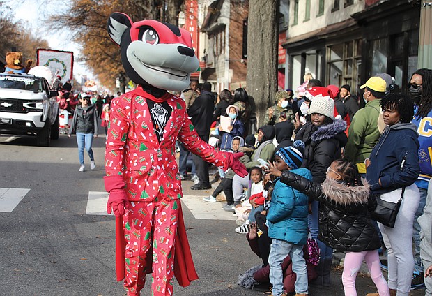 Characters interacted with youngsters along the parade route. Nutzy, the mascot of the Richmond Flying Squirrels, shows off his holiday attire.