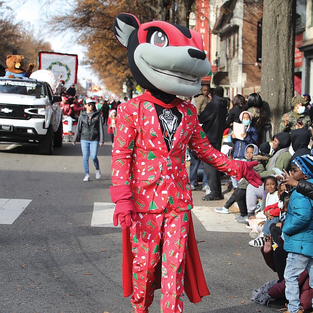 Characters interacted with youngsters along the parade route. Nutzy, the mascot of the Richmond Flying Squirrels, shows off his holiday attire.