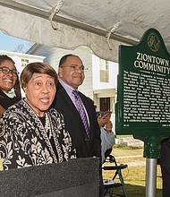 A new historic marker recognizing the Ziontown community in Henrico County was dedicated Dec. 3 in a ceremony hosted by the Family & Friends of Ziontown and the Henrico Historic Preservation Advisory Committee as part of the Historical Roadside Marker program.The community was founded in 1870 by Henry Pryor, a formerly enslaved man, who purchased 5 acres around the area now known as Ridge Road at Fountain Lane and extending south to River Road. He named the settlement Ziontown, meaning Heavenly Place. The community grew to include about 50 homes with up to 275 residents. Subdivisions have encroached upon the area in recent decades. Last week’s celebration drew longtime residents, as well as those who grew up in the area and others with ties to the community, including the Lambert family, whose home in the 8300 block of Ridge Road served as the site of the dedication. Among the attendees are, from left, John A. Lambert Sr.; Richmond City Councilwoman Ann-Frances Lambert; Brenda Dabney Nichols, who led the marker effort; Richard A. Lambert; the Rev. Larry Collins; and Dr. Colita Nichols Fairfax.