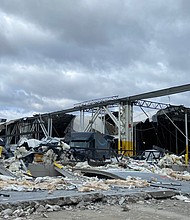 This National Weather Service photo shows the damage to the south side of an Amazon warehouse in Edwardsville. The facility was hit by an EF3 tornado on Friday night, according to a preliminary report from the NWS, killing six and causing multiple injury. (Photo credit: National Weather Service)