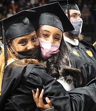 Haben Yosef, left, hugs her friend and classmate Tracy Demiss during last Saturday’s commencement ceremony at Virginia Commonwealth University’s Siegel Center. The two are both from Arlington and interdisciplinary studies majors.