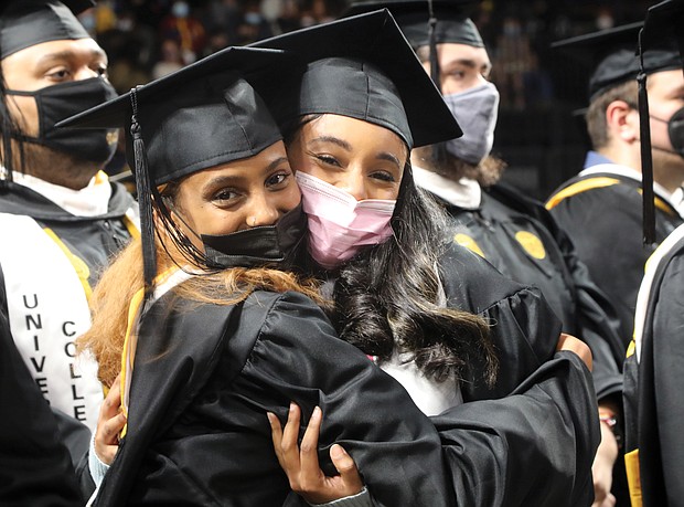Haben Yosef, left, hugs her friend and classmate Tracy Demiss during last Saturday’s commencement ceremony at Virginia Commonwealth University’s Siegel Center. The two are both from Arlington and interdisciplinary studies majors.