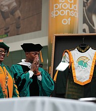 Award-winning musician and Virginia Beach native Pharrell Williams is overcome with emotion last Saturday as he is made an honorary member of the Norfolk State University Spartan Legion Marching Band and presented with a framed band uniform by NSU President Javaune Adams-Gaston. He also was awarded an honorary doctorate by the university.