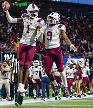 South Carolina State wide receivers Shaquan Davis, left, and Will Vereen celebrate the Bulldogs’ 31-10 victory over Jackson State University last Saturday in the Celebration Bowl in Atlanta. With five receptions for 95 yards and three touchdowns, Davis was named MVP.