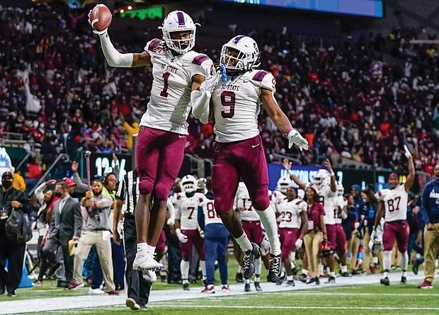 South Carolina State wide receivers Shaquan Davis, left, and Will Vereen celebrate the Bulldogs’ 31-10 victory over Jackson State University last Saturday in the Celebration Bowl in Atlanta. With five receptions for 95 yards and three touchdowns, Davis was named MVP.