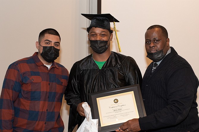 Vernon Owens, Director of Programs of The Dovetail Project, with a graduate of the program aimed to make young fathers better men and better members of their communities. Photo provided by Aileen Bedeau.