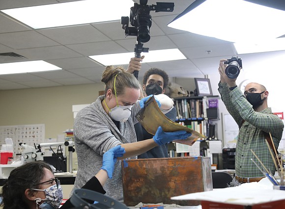 Conservation experts at the Virginia Department of Historic Resources pulled books, money, ammunition, documents and other artifacts Tuesday from a ...