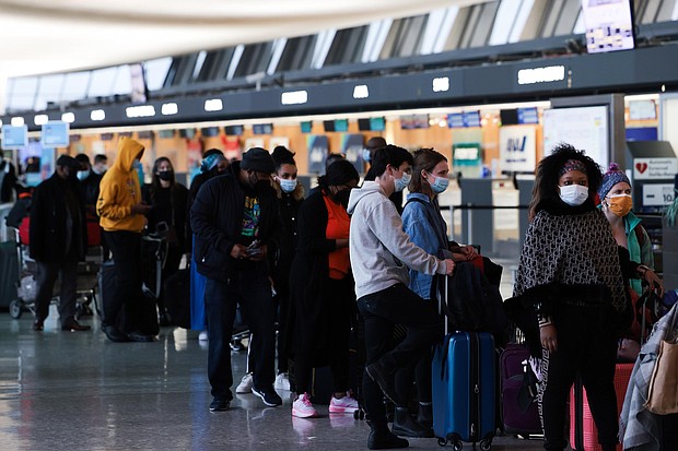 Passengers wait in line to check-in for their flights at the Dulles International Airport in Dulles, Virginia, on December 27.
	Anna Moneymaker/Getty Images