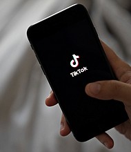 Signage for ByteDance Ltd.'s TikTok app is displayed on a smartphone in an arranged photograph taken in Arlington, Virginia, U.S., on Monday, Aug. 3, 2020.
	Andrew Harrer/Bloomberg/Getty Images