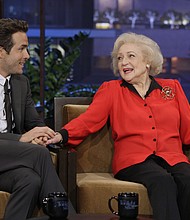 Ryan Reynolds, here with Betty White during an interview in 2010, is among the friends and colleagues remembering the late actress.
	Paul Drinkwater/NBC/Getty Images