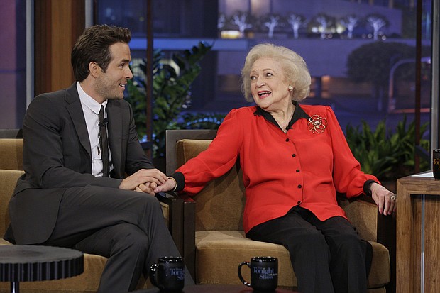 Ryan Reynolds, here with Betty White during an interview in 2010, is among the friends and colleagues remembering the late actress.
	Paul Drinkwater/NBC/Getty Images