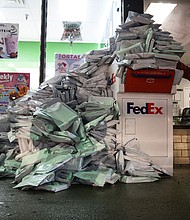 At-home Covid-19 tests from Chicago Public  School students pile up at a FedEx drop-off box in the West Elsdon neighborhood of Chicago on December 28.
	E. Jason Wambsgans/Chicago Tribune/Tribune News Service/Getty Images