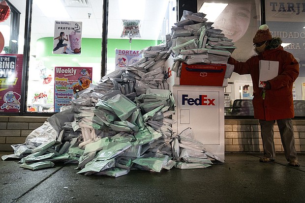 At-home Covid-19 tests from Chicago Public  School students pile up at a FedEx drop-off box in the West Elsdon neighborhood of Chicago on December 28.
	E. Jason Wambsgans/Chicago Tribune/Tribune News Service/Getty Images
