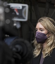 Former Theranos CEO Elizabeth Holmes leaves federal court in San Jose, Calif., Thursday, Dec. 23.
Mandatory Credit:	Nic Coury/AP