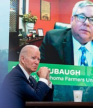President Joe Biden attends a virtual meeting with family and independent farmers and ranchers including Scott Blubaugh, President, Oklahoma Farmers Union, visible on the monitor.
Andrew Harnik/AP