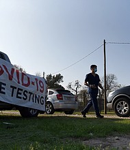 Healthcare workers operate a COVID-19 drive-through testing site as the Omicron variant of the coronavirus continues to spread through the country in Houston, Texas, in 2021.
	Callaghan O'Hare/Reuters