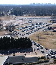 Massive rows of cars line up Jan. 30 outside Richmond Raceway in Henrico County, where area health department officials administered the new vaccine to seniors and people with underlying healthCOVID-19 conditions.