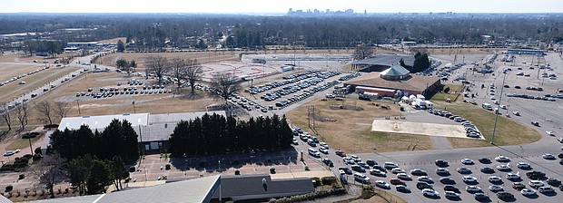Massive rows of cars line up Jan. 30 outside Richmond Raceway in Henrico County, where area health department officials administered the new vaccine to seniors and people with underlying healthCOVID-19 conditions.
