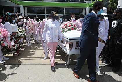 Pallbearers accompany the casket shared by Sharnez Hill, 30, and her 3-month-old daughter, Neziah Hill, after their funeral May 8 at United Nations Church in South Side, where hundreds of mourners paid their final respects. The mother and daughter were shot and killed April 27, and three other people, including 11- and 15-year- old girls, were wounded outside the Belt Atlantic Apartments in South Side by young men shooting at each other across the apartment complex courtyard.