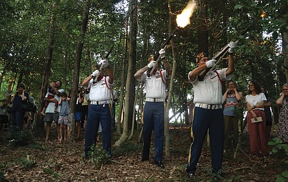 Members of the Veterans of Foreign Wars Post 9808 in Mechanicsville lead a three-volley salute during a twilight memorial ceremony July 28 held at the Sons and Daughters of Ham Cemetery near Bandy Field in Henrico County. The ceremony, held on National Buffalo Soldiers Day, honored Moses Bradford Jr., a Buffalo Soldier who served in the 25th Infantry during the Spanish-American War. He is buried in the cemetery.