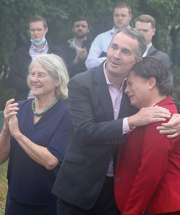 An emotional state Sen. Jennifer L. McClellan, head of the Dr. Martin Luther King Jr. Memorial Commission that spearheaded the creation of the monument, is comforted by Gov. Ralph S. Northam as Delegate Betsy B. Carr, left, applauds the unveiling. Many in the crowd also shed tears during the ceremony.